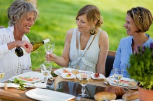 7625984-woman-pouring-wine-in-glass-for-daughter-at-dining-table